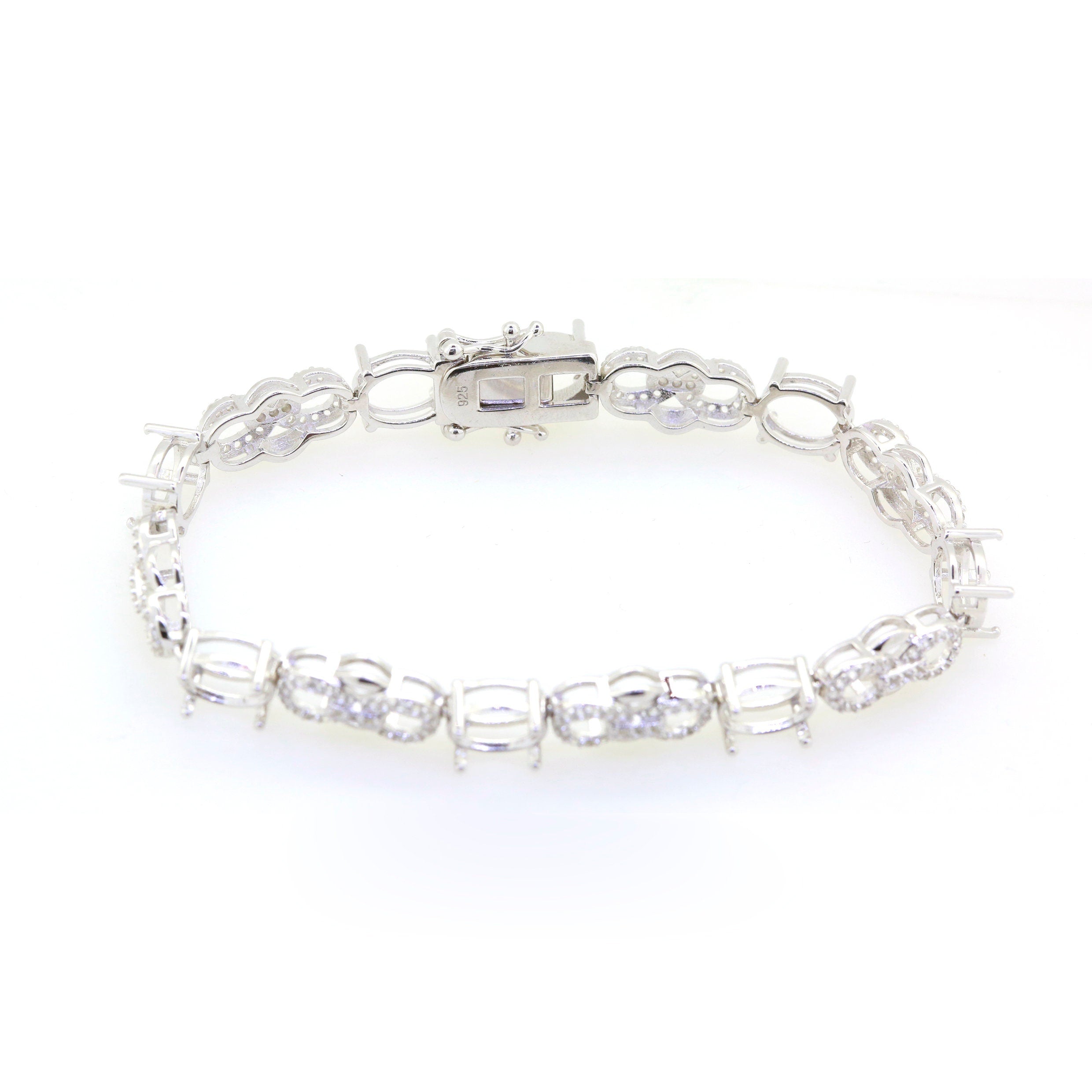 Sterling silver semi mount tennis bracelet setting with oval white topaz accents and stainless steel tongue.