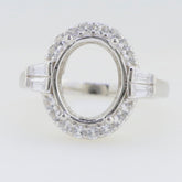Sterling Silver semi mount ring setting with oval halo of white topaz, ready for custom gemstone placement.