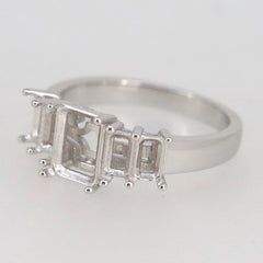 Sterling silver semi mount ring setting with placeholder for emerald and accent stones, customizable sizes available.