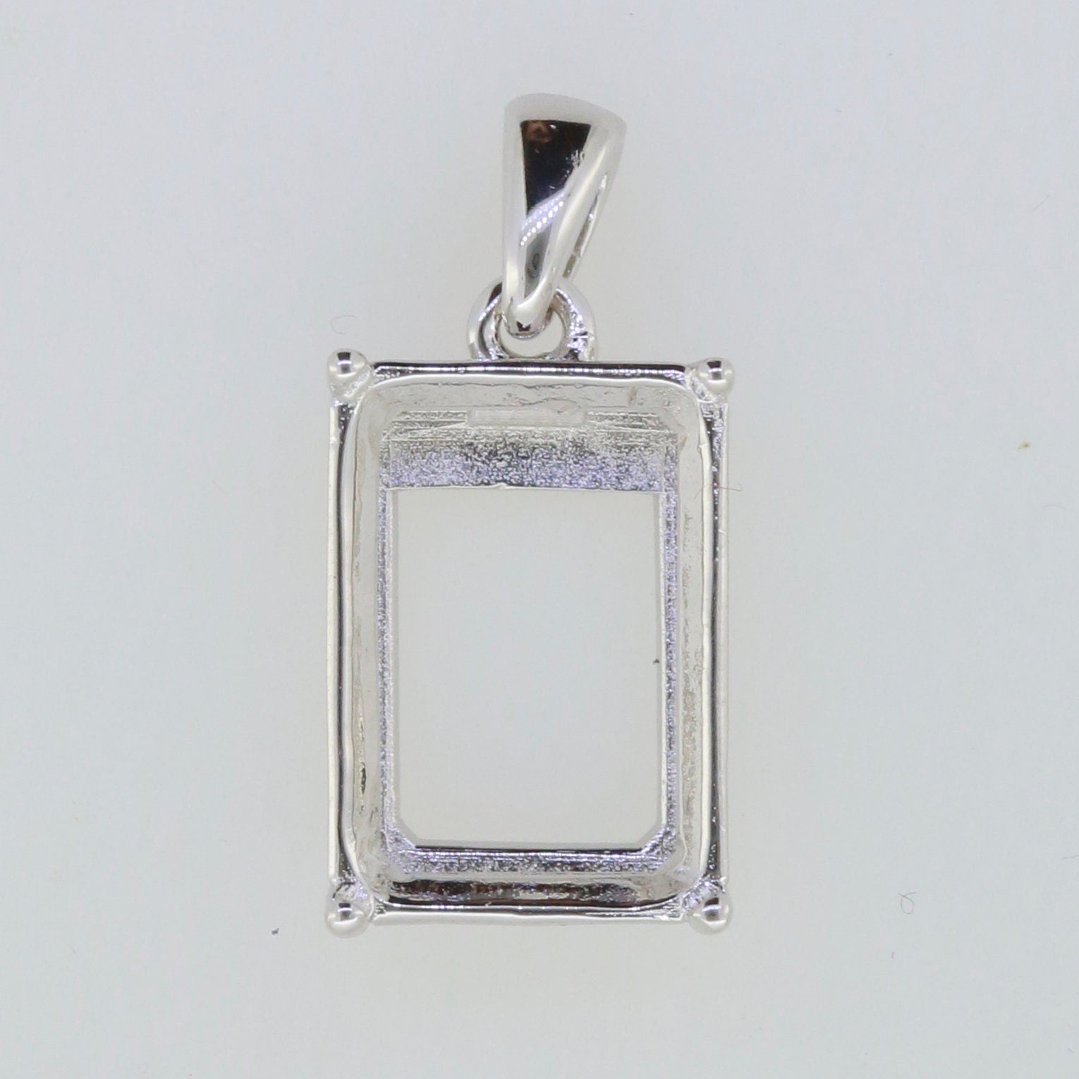 Sterling silver semi mount pendant setting for emerald, 17.14 × 15.25 × 12.88 mm, made to order design.