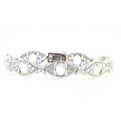 Sterling silver semi mount tennis bracelet setting with oval accents and white topaz, designed for custom sizing.