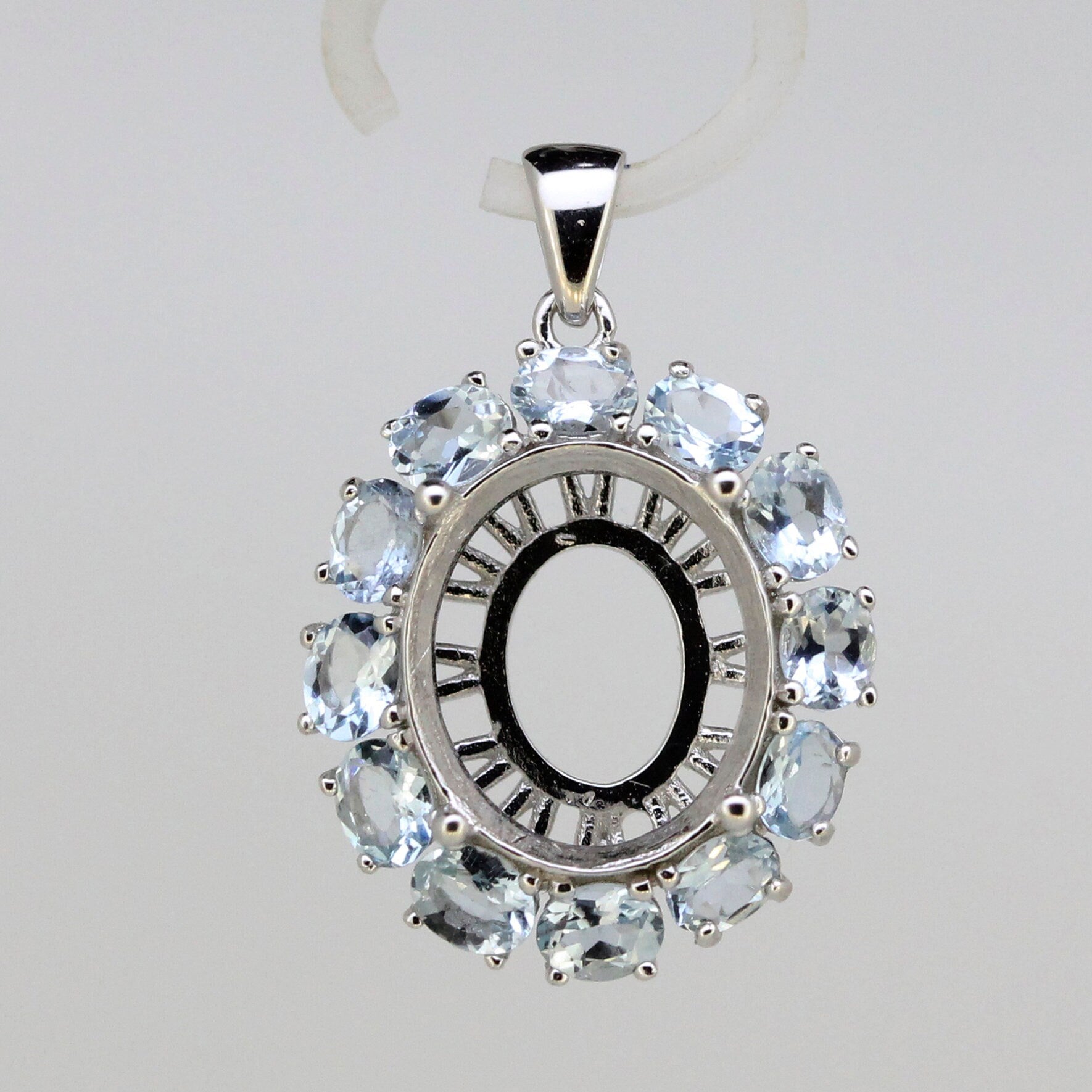 Sterling silver semi mount pendant setting with oval halo design and aquamarine gemstones, handmade to order.