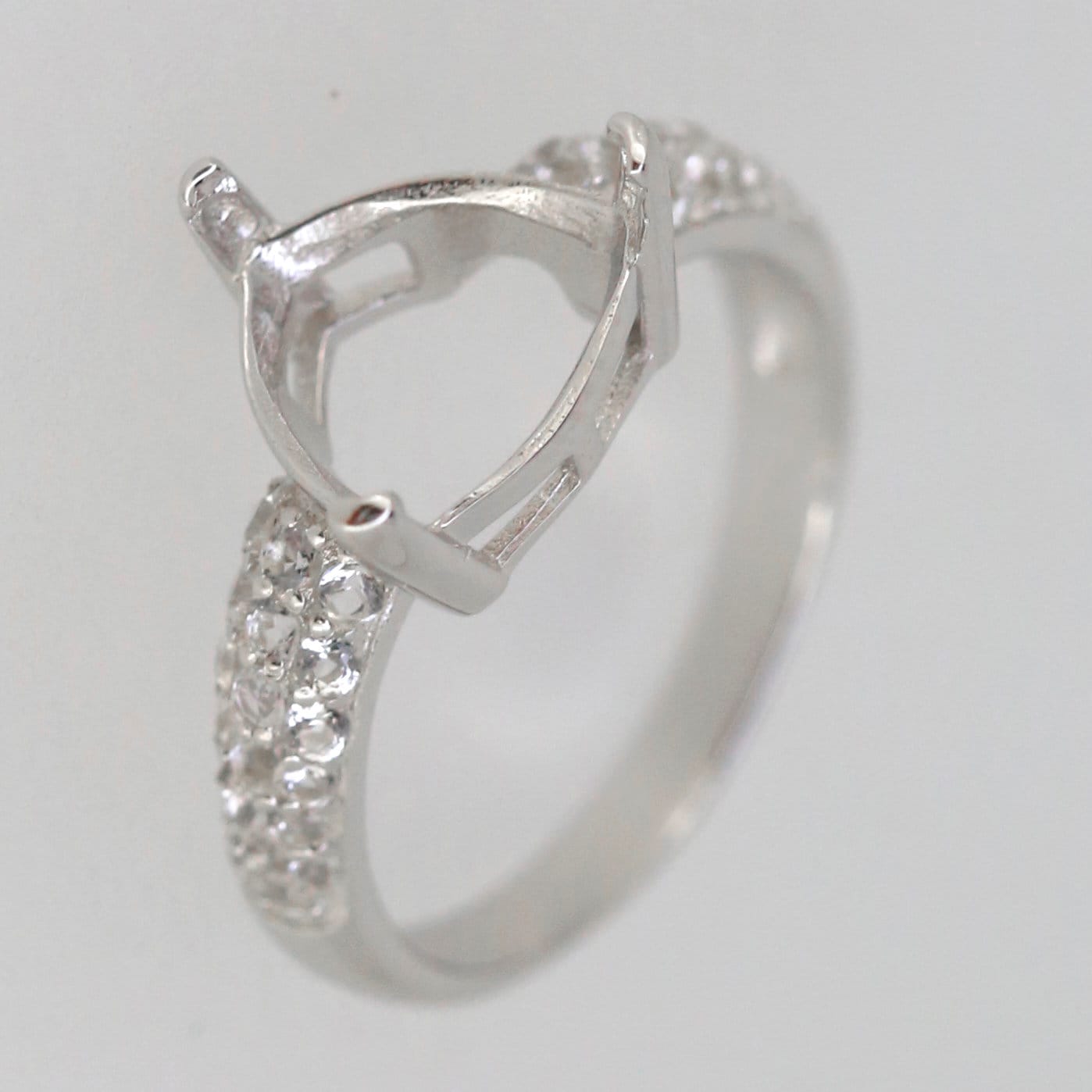 Sterling silver semi mount ring setting with moissanite accents, featuring a trillion shape for custom gemstones.