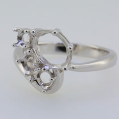 Sterling silver semi mount ring setting for 9x7mm oval gemstone and 4x4mm round gemstones, ideal for custom jewelry.