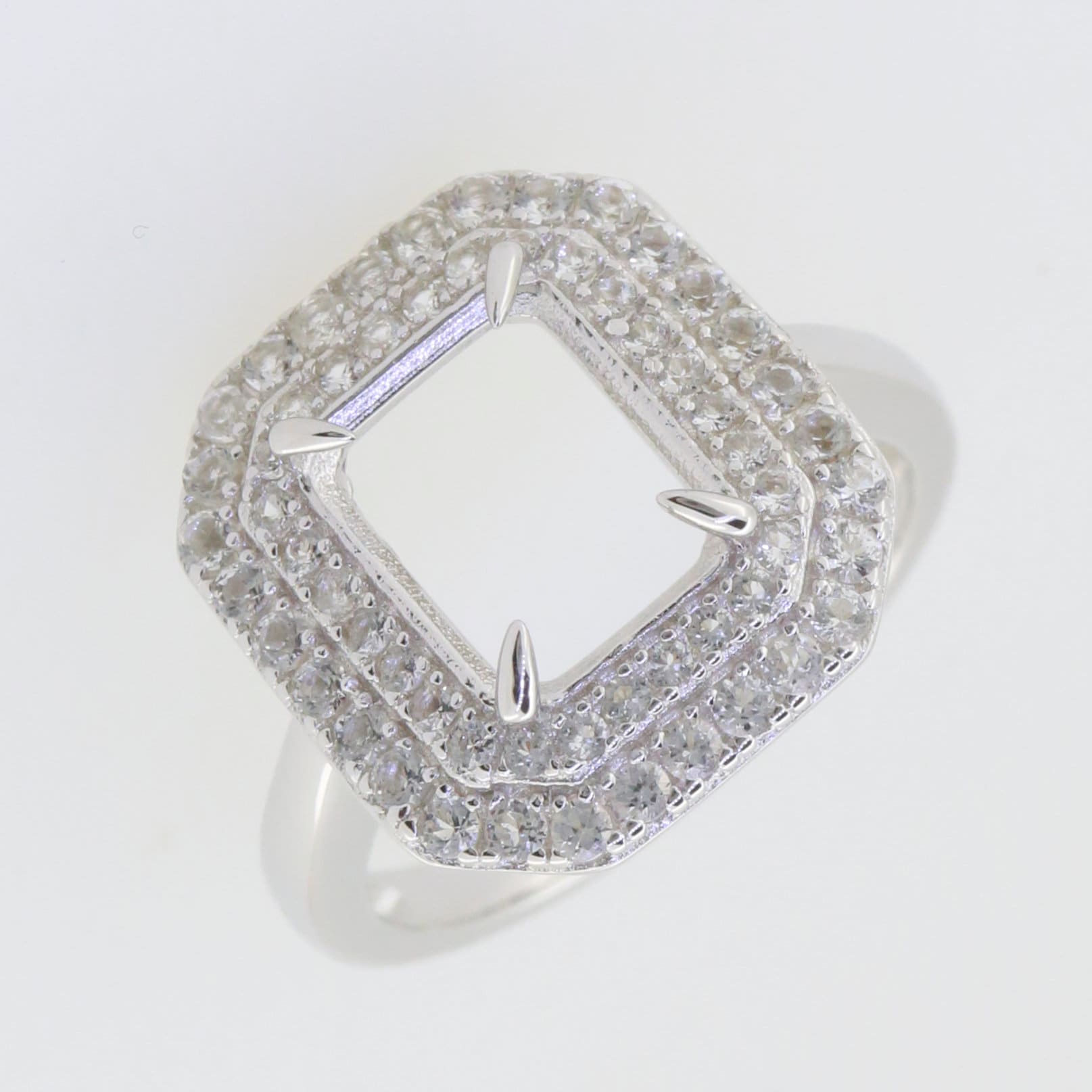 Sterling silver semi mount ring setting featuring double halo with white topaz, designed for 10x8mm emerald centerpiece.