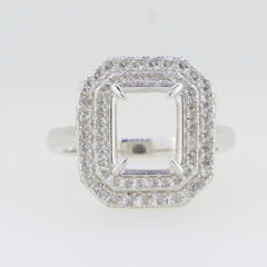 Custom sterling silver semi mount ring setting for emerald 10x8mm with double halo and white topaz accents.
