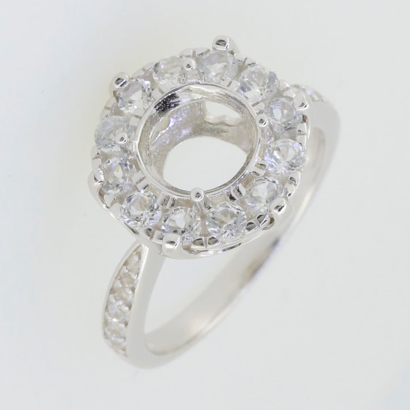 Sterling silver semi mount ring setting featuring an 8x8mm round halo with moissanite accents, ready for customization.