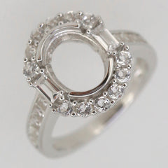 Sterling silver semi mount ring setting with oval halo for 10x8mm gemstone, featuring baguette accents.