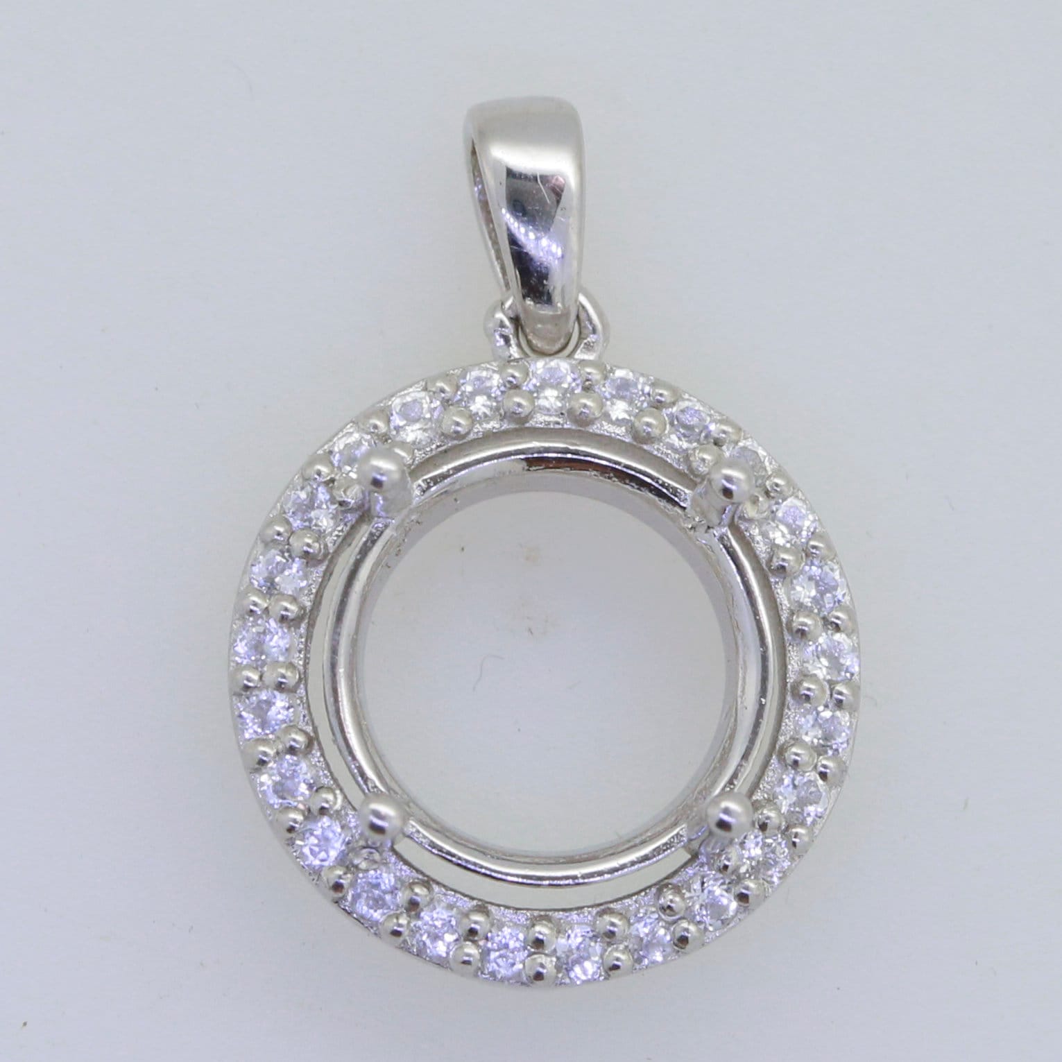 Sterling silver semi mount pendant setting with white topaz halo, round 13x13mm for custom gemstone placement.