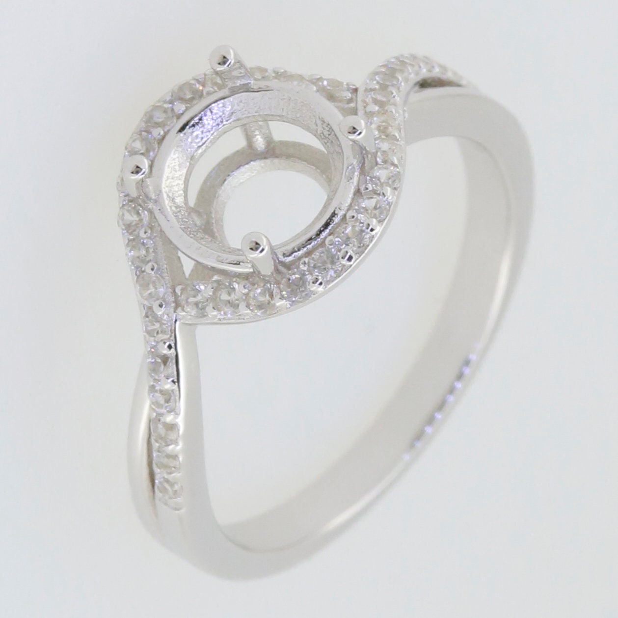 Sterling silver semi mount ring setting featuring moissanite accents and a round 8x8mm halo design.