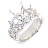 Sterling silver semi mount ring setting with swirling cross shank and moissanite detailing, perfect for engagement.