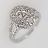 Sterling silver semi mount ring setting with oval design, split shank halo, and white topaz accents.
