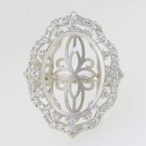 Sterling silver semi mount ring setting with oval halo design for cabochon stone and moissanite accents.