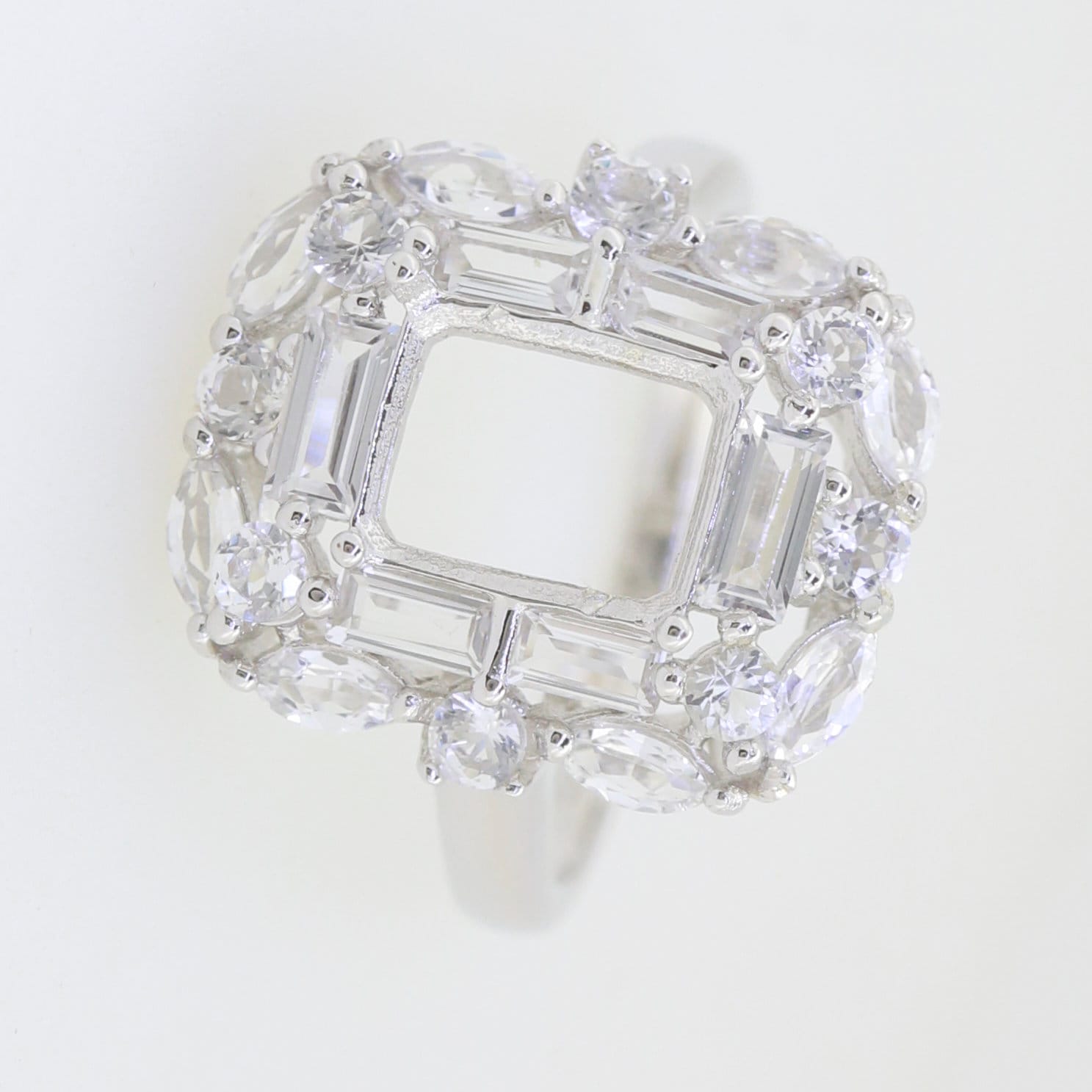 Sterling silver semi mount ring setting with emerald octagon 9x7mm and double halo, featuring baguette and marquise stones.