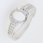 Sterling silver semi mount bypass ring setting with moissanite accents for 8x6mm oval gemstone.