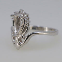 Sterling silver semi mount pear ring setting with white topaz accents, designed for custom gemstone fitting.