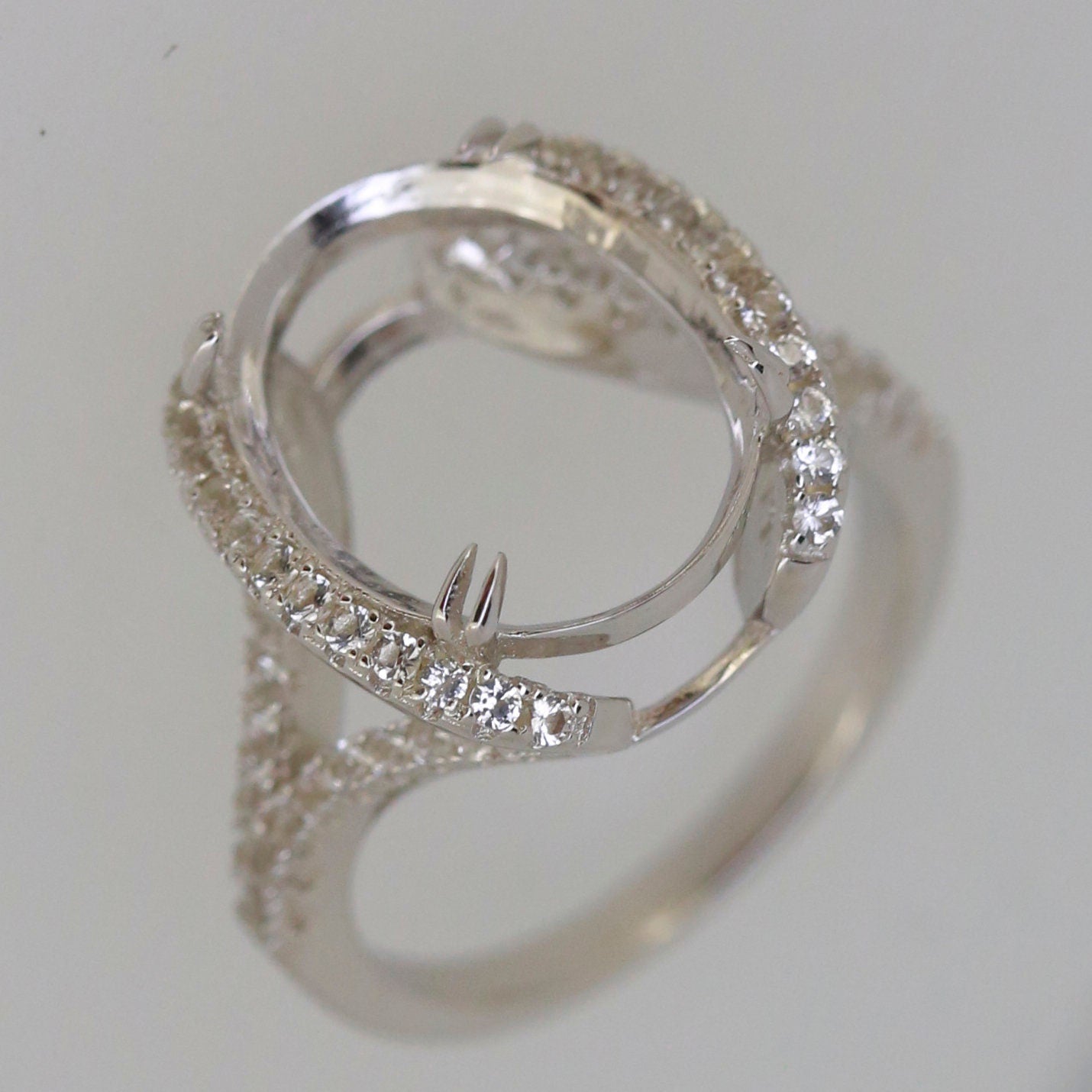 Sterling silver semi mount halo ring setting with white topaz gemstones ready for custom main stone.