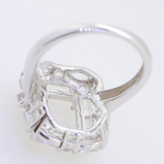 Sterling silver semi mount ring setting, featuring a hollow design for 9x7mm emerald with baguette and marquise halo.