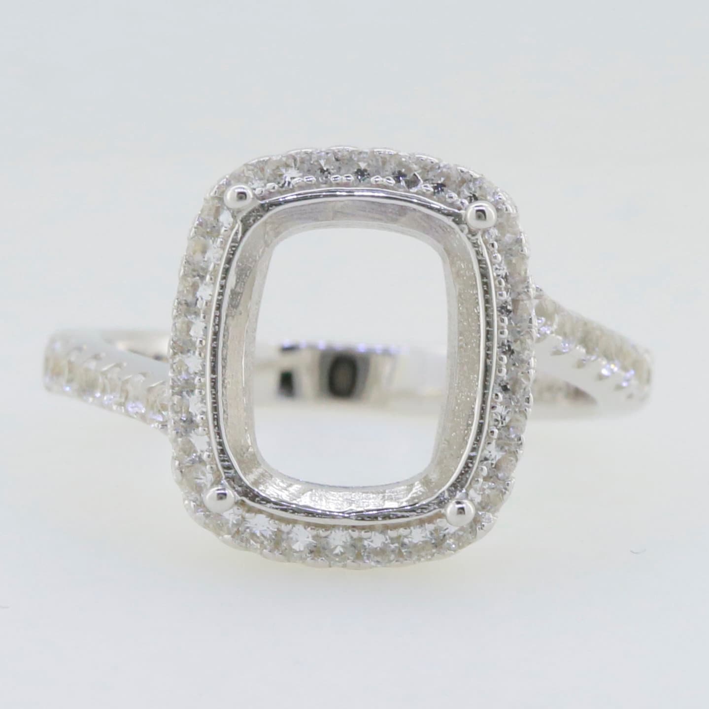 Sterling silver semi mount ring setting with cushion shape for a 12x10mm gemstone, featuring white topaz accents.