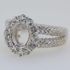 Sterling silver semi mount ring setting with oval halo for 9x7mm gemstones and white topaz accents.