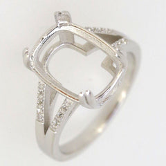 Sterling silver semi mount ring setting with oval shape and split shank design, featuring stones for added elegance.