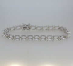 Sterling silver semi mount tennis bracelet setting with oval openings for gemstones and stainless steel clasp.