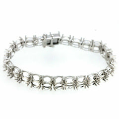 Sterling silver semi mount tennis bracelet setting featuring oval 7x5mm stone placeholders in a double row design.