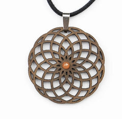 Intricate wooden pendant with geometric design and orange gemstone centerpiece on a black cord.