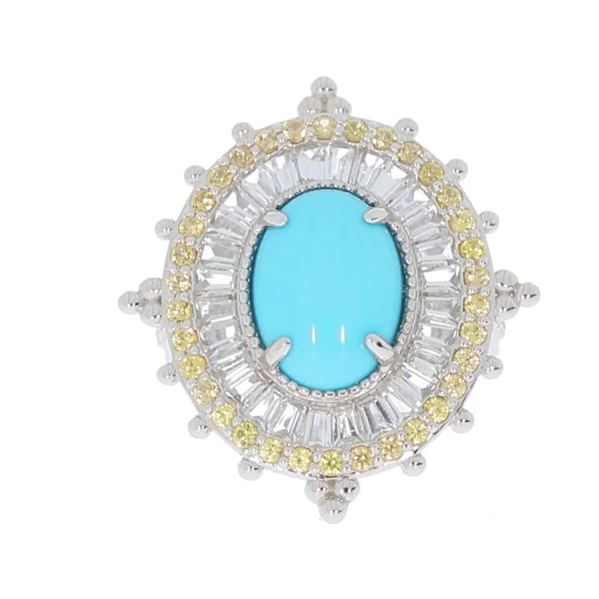 Oval blue turquoise ring with sapphire and yellow gemstone accents in sterling silver setting.