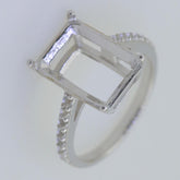 Sterling silver semi mount ring setting for emerald with white topaz accent, ready for custom gemstone fitting.