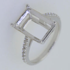 Sterling silver semi mount ring setting for emerald with white topaz accent, ready for custom gemstone fitting.