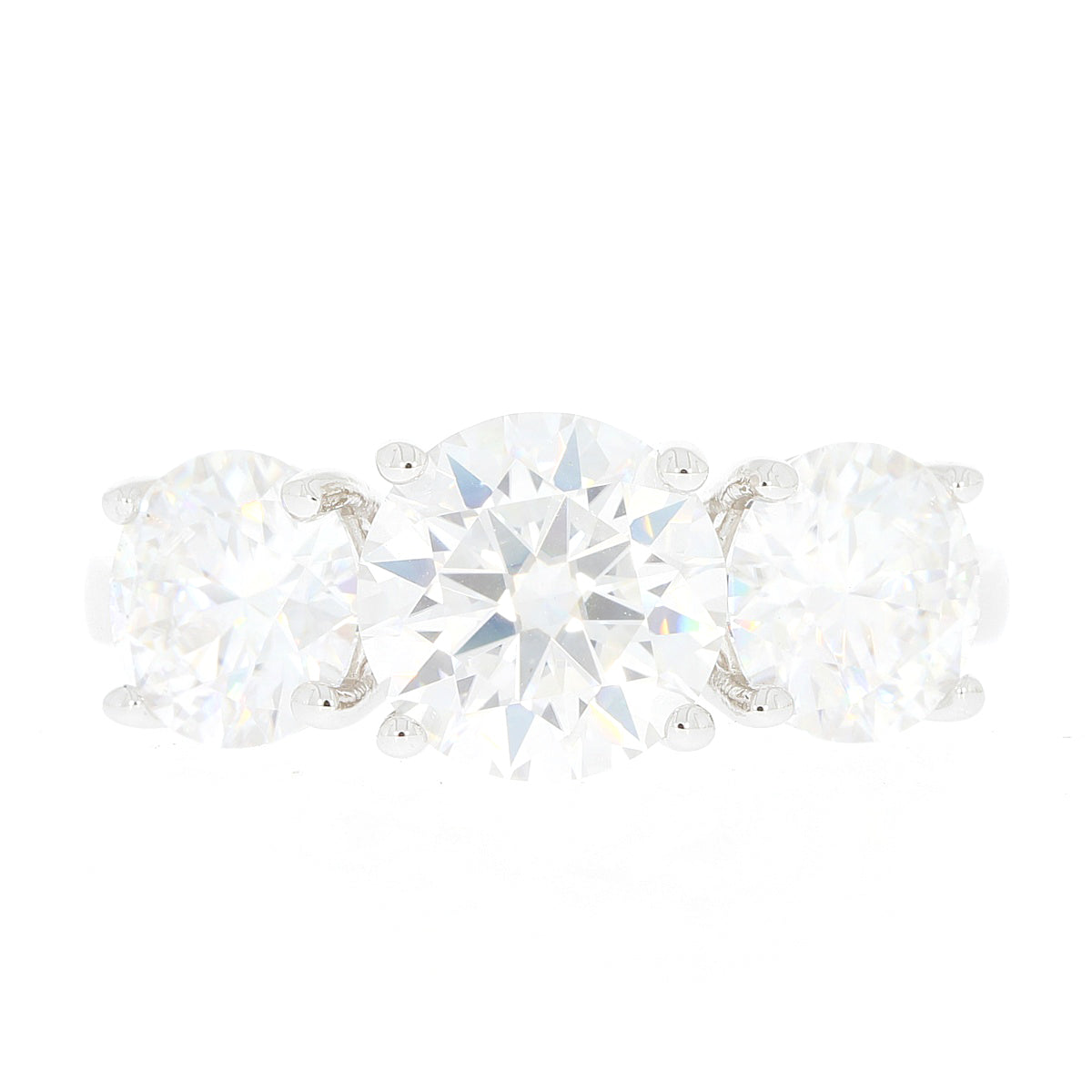 Round cut sterling silver ring with three sparkling Moissanite stones, showcasing elegance and luxury.