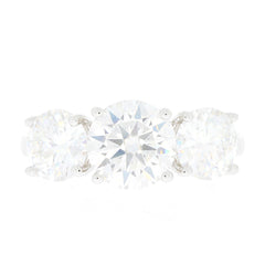 Round cut sterling silver ring with three sparkling Moissanite stones, showcasing elegance and luxury.