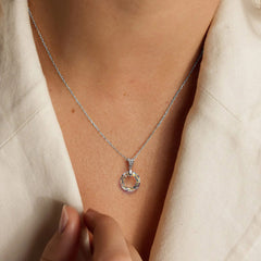 Sterling silver round circle pendant necklace featuring a multi-color Austria crystal, model wearing an 18-inch chain.