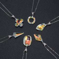 Sterling silver necklaces with colorful Austria crystal pendants in various shapes on a dark background