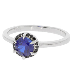 Elegant blue sapphire ring in sterling silver, accented by black stones for a luxurious touch.