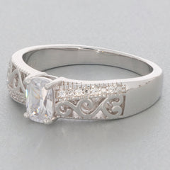 Cushion cut Moissanite sterling silver ring with intricate detailing and sparkling accents.