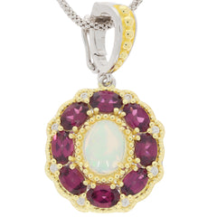 Oval white opal pendant with ruby accents, set in gold and silver, perfect for elegant jewelry collections.