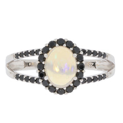 Oval white opal sterling silver ring with black gemstone accents, elegant and luxurious design.