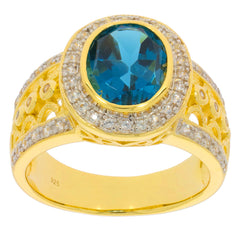 Elegant gold ring featuring a large oval blue topaz stone surrounded by sparkling diamonds, perfect for special occasions.