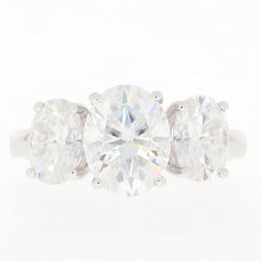 Elegant white Moissanite sterling silver ring featuring three sparkling gemstones.