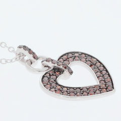 Red diamond heart pendant in sterling silver, featuring sparkling gemstones for an elegant accessory.