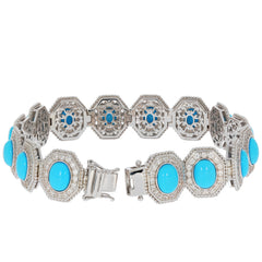 Oval blue turquoise sterling silver bracelet with sparkling gemstone accents, showcasing elegant design.