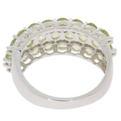 Elegant silver ring with peridot gemstones, showcasing intricate detailing and a polished finish.