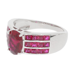 Oval red ruby sterling silver ring with ruby accents, showcasing a sparkling gemstone in an elegant design.