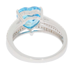 Heart-shaped blue topaz gemstone in a sterling silver ring, showcasing elegant design and sparkling beauty.