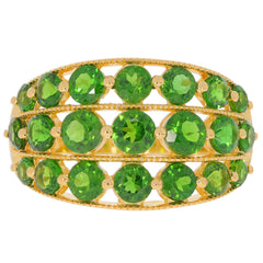 Elegant gold ring adorned with multiple round green chrome diopside gemstones, showcasing luxurious craftsmanship.