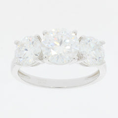 Three-stone ring in sterling silver featuring large round clear gemstones, showcasing timeless elegance and luxury.