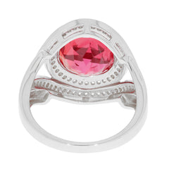 Round pink sapphire ring in sterling silver setting, featuring a sparkling gemstone from a side view.