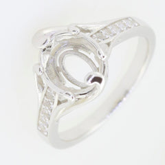 Sterling silver ring setting designed for an oval gemstone, showcasing intricate details and sparkling accents.